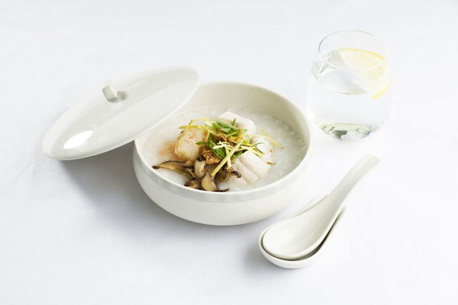 Chinese congee, steamed seafood with shiitake mushrooms and garnishes